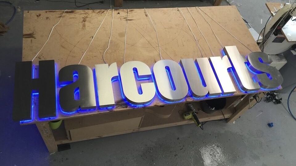 3d fabricated and halo illuminated stainless steel lettering